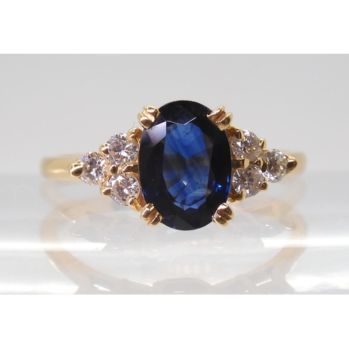 2768 - A FRENCH SAPPHIRE & DIAMOND RINGset with an 8mm x 5.8mm x 3.4mm, the shoulders are set with thre... 