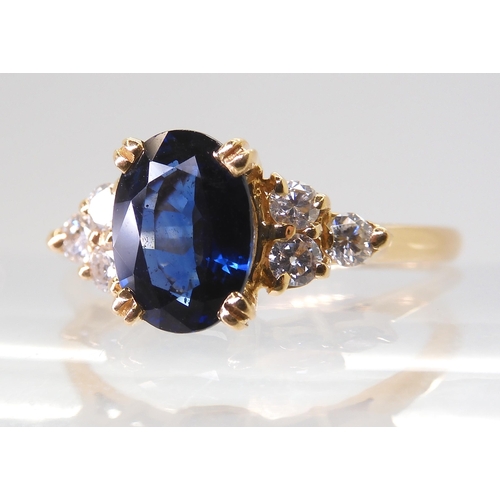 2768 - A FRENCH SAPPHIRE & DIAMOND RINGset with an 8mm x 5.8mm x 3.4mm, the shoulders are set with thre... 