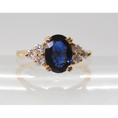 2768 - A FRENCH SAPPHIRE & DIAMOND RINGset with an 8mm x 5.8mm x 3.4mm, the shoulders are set with thre... 