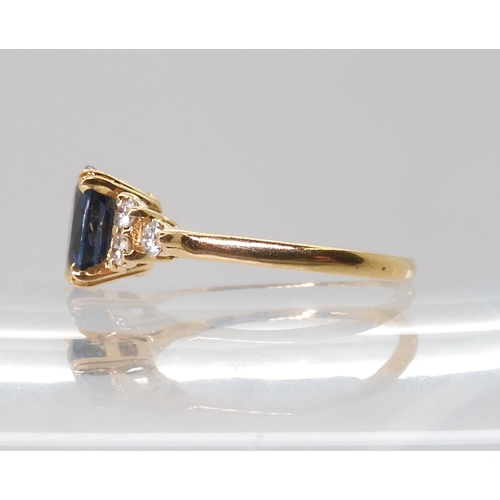 2768 - A FRENCH SAPPHIRE & DIAMOND RINGset with an 8mm x 5.8mm x 3.4mm, the shoulders are set with thre... 