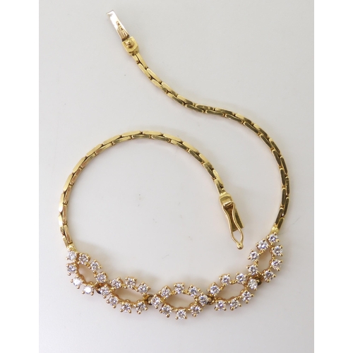 2779 - AN 18CT GOLD DIAMOND BRACELETwith a fancy box chain and marquis-shaped links set with estimated appr... 