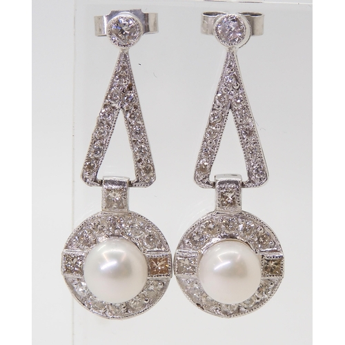 2780 - A PAIR OF DIAMOND & PEARL EARRINGSthe white pearls are approximately 6.4mm and surrounded with p... 