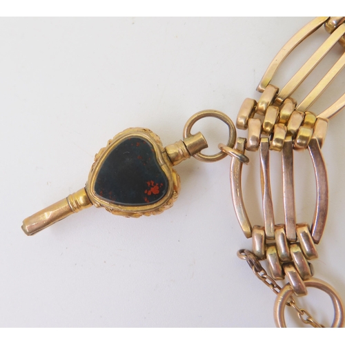 2805 - A 9CT GOLD GATE BRACELETwith a heart-shaped clasp, heart shaped agate and crystal-shaped watch key, ... 