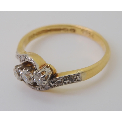 2813 - A VINTAGE THREE STONE RINGset in 18ct gold and platinum the three diamonds have an estimated combine... 