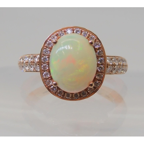 2816 - A LE VIAN OPAL & DIAMOND RINGmounted in 14k rose gold, and set with estimated approx 0.50cts of ... 