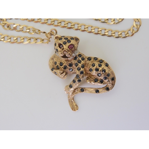 2819 - A 9CT GOLD LEOPARD PENDANT/BROOCHwith sapphire spots and ruby eyes, dimensions 3.5cm x 3.8cm, with a... 