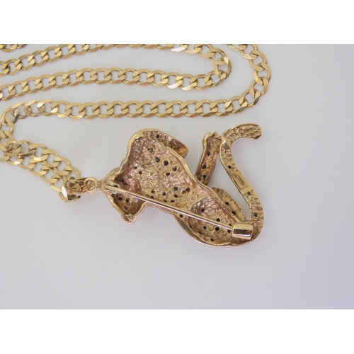 2819 - A 9CT GOLD LEOPARD PENDANT/BROOCHwith sapphire spots and ruby eyes, dimensions 3.5cm x 3.8cm, with a... 