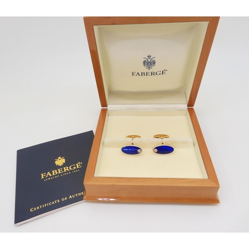 2822 - A PAIR OF FABERGE CUFFLINKSin 18ct gold, guilloche enameled in cobalt blue and white and set with a ... 