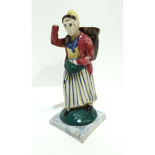 275 - A Scottish pottery figure modelled as a fisherwoman, carrying a creel on her back