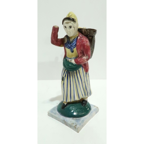 275 - A Scottish pottery figure modelled as a fisherwoman, carrying a creel on her back