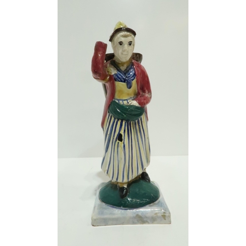 275 - A Scottish pottery figure modelled as a fisherwoman, carrying a creel on her back