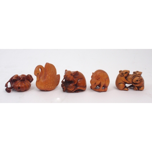 312 - A collection of Japanese fruitwood netsuke, one carved as a swan, the other as a monkey clutching a ... 