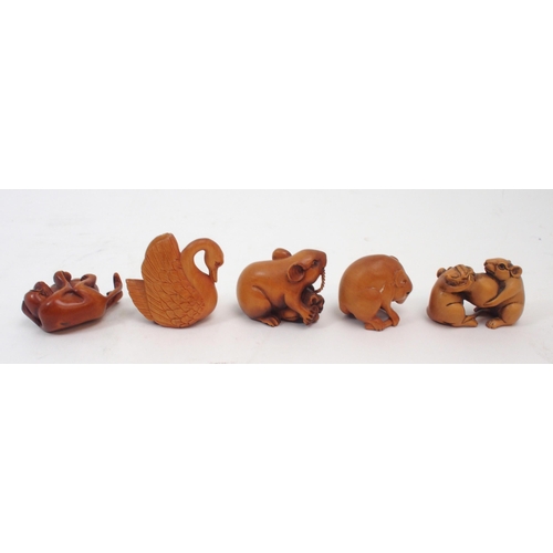 312 - A collection of Japanese fruitwood netsuke, one carved as a swan, the other as a monkey clutching a ... 