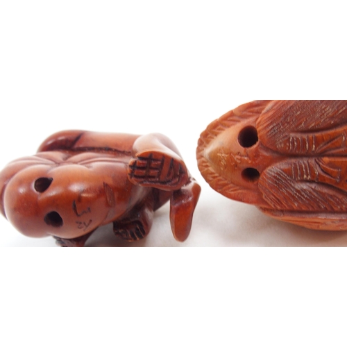 312 - A collection of Japanese fruitwood netsuke, one carved as a swan, the other as a monkey clutching a ... 