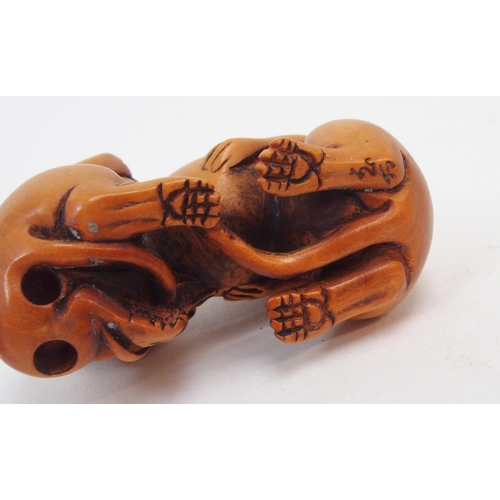 312 - A collection of Japanese fruitwood netsuke, one carved as a swan, the other as a monkey clutching a ... 