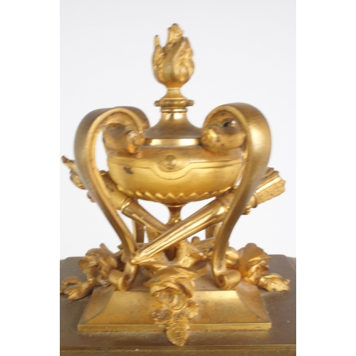 320 - A French gilded brass and glass timepiece, of tall rectangular form, the top with flaming urn and to... 