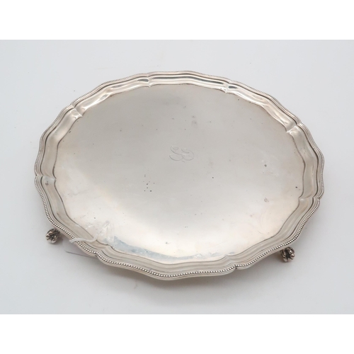 426 - A George VI silver salver, by Barker Brothers Silver ltd, of lobed form with a beaded border, on fou... 