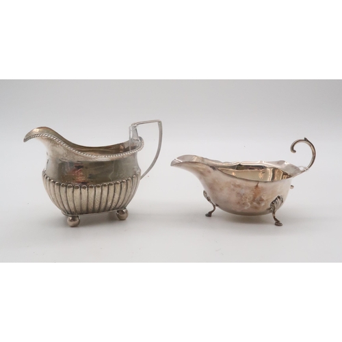 430 - A George III silver cream jug, London 1809 (maker's mark rubbed), the body half fluted, and a silver... 