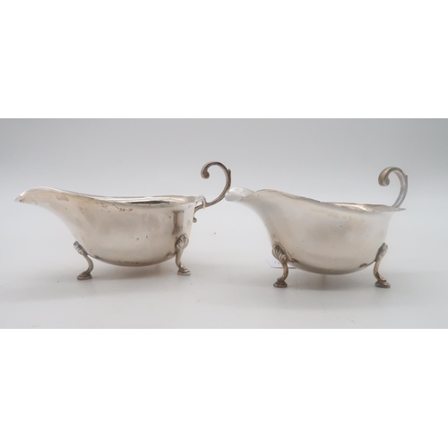 436 - A pair of silver sauce boats, by L & R, Birmingham 1932, in the George III style, with a flying ... 