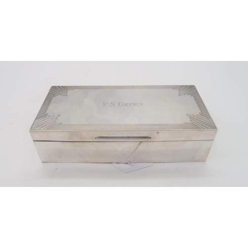 445 - A George V silver cigarette box, by William Hutton & Sons, London 1932, the lid with Art Deco en... 