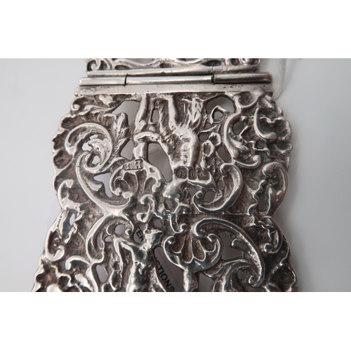 447 - A Victorian silver belt buckle, by Thomas Hayes, London 1878, finely cast with a hunting scene, and ... 