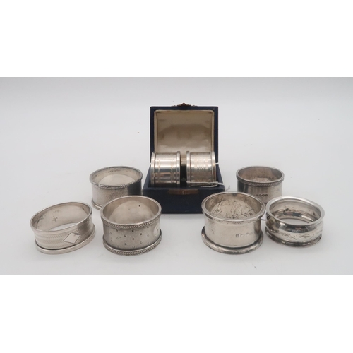 452 - A collection of silver napkin rings, including a cased pair by Henry Griffith & Sons, Birmingham... 