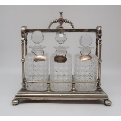 478 - A three bottle tantalus, with an EPNS stand by Fenton brothers, with three silver spirit labels, Gin... 