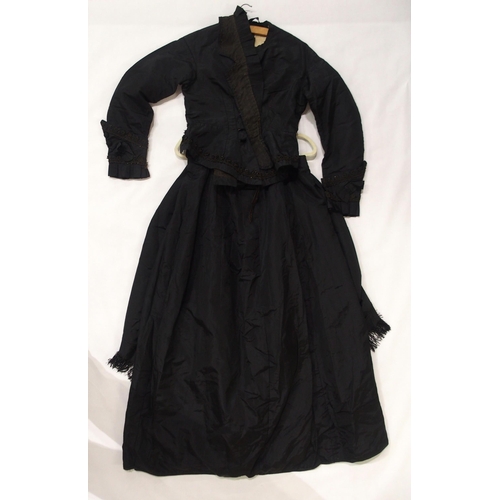 250 - A Victorian black satin skirt bustle, bodice and collar, the inside edges of the material printed wi... 