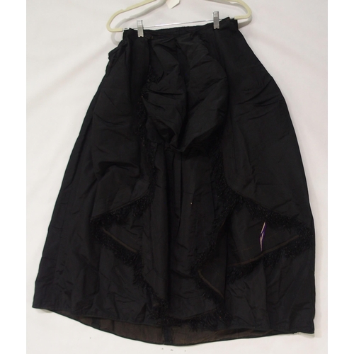 250 - A Victorian black satin skirt bustle, bodice and collar, the inside edges of the material printed wi... 