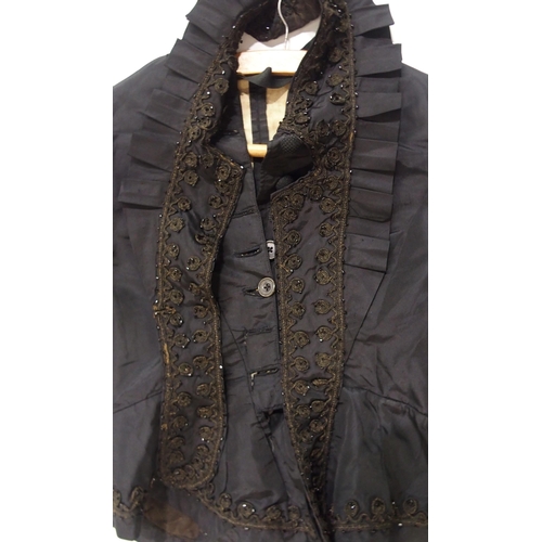 250 - A Victorian black satin skirt bustle, bodice and collar, the inside edges of the material printed wi... 