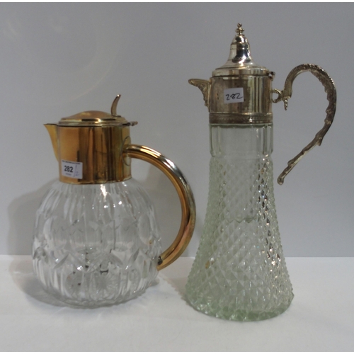 282 - A large silver plated and cut glass lemonade jug with central glass cooling cylinder, and a wine jug... 