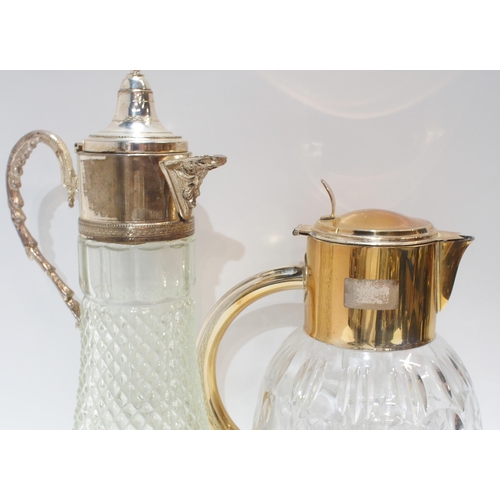 282 - A large silver plated and cut glass lemonade jug with central glass cooling cylinder, and a wine jug... 