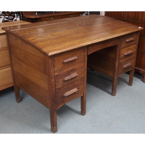 46 - An early 20th century oak clerks desk with sloped writing top over single central drawer flanked by ... 