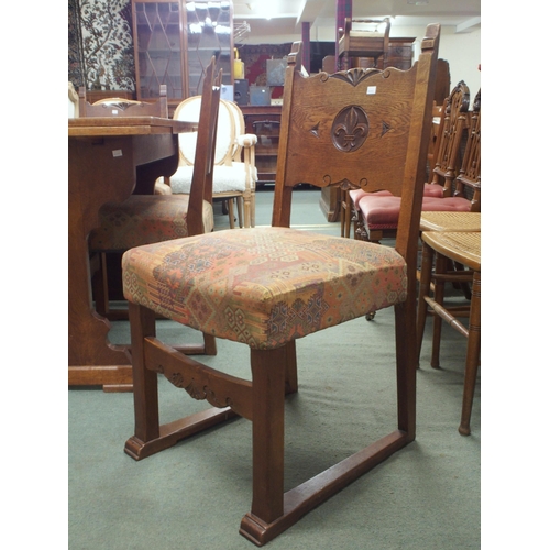 49 - A 20th century French oak dining suite consisting refectory style pull out extending dining table wi... 