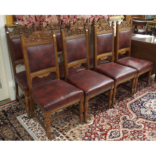 63 - A set of eight Victorian oak dining chairs with burgundy leather upholstered splats and seats on tur... 