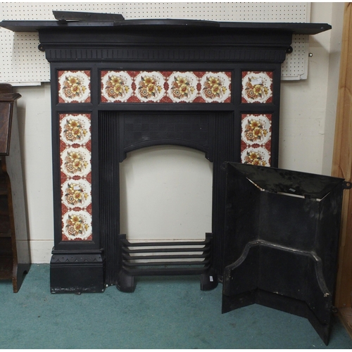 75 - A 19th century cast iron combination fireplace/insert with iron mantle over floral tile inset surrou... 