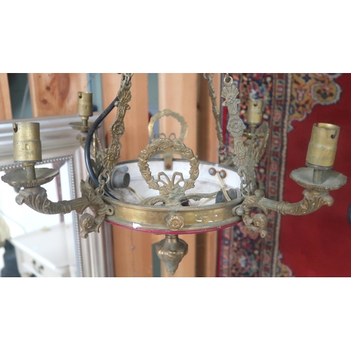 82A - An early 20th century brass Rococo style four branch chandelier with cast brass hanging chains, 69cm... 