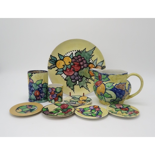 2183 - ELIZABETH MARY WATT (SCOTTISH 1886-1954)A collection of fruit painted pottery, including a plate, 24... 