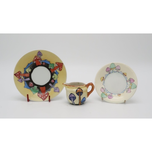 2196 - ELIZABETH MARY WATT (SCOTTISH 1886-1954)Two Toadstool painted porcelain saucers and a pottery miniat... 