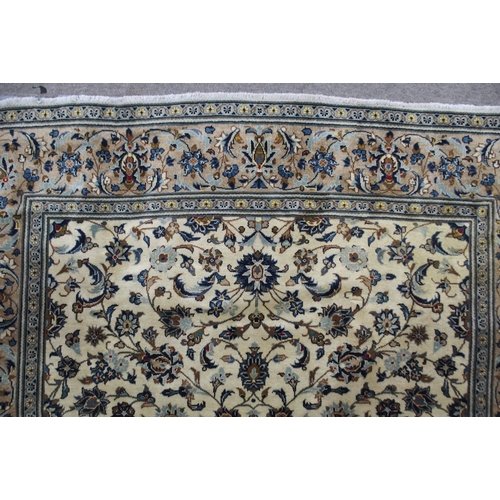 2136 - A CREAM GROUND KASHAN RUGwith all over floral ground and flower head border, 297cm long x 194cm wide... 