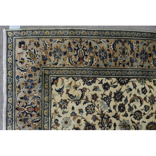 2136 - A CREAM GROUND KASHAN RUGwith all over floral ground and flower head border, 297cm long x 194cm wide... 