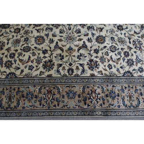 2136 - A CREAM GROUND KASHAN RUGwith all over floral ground and flower head border, 297cm long x 194cm wide... 