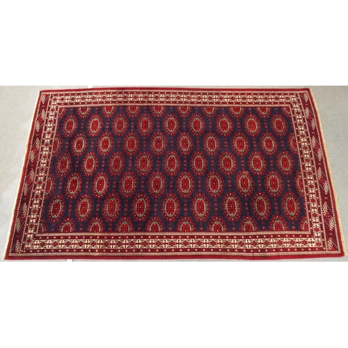 2137 - A DARK BLUE GROUND TURKMAN RUGwith all-over geometric lozenge design and multicolour geometric borde... 