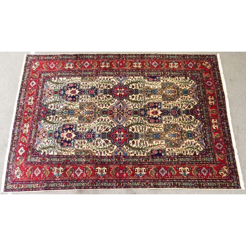 2139 - A CREAM GROUND TABRIZ RUGwith all-over multicoloured floral geometric design and red flower head bor... 