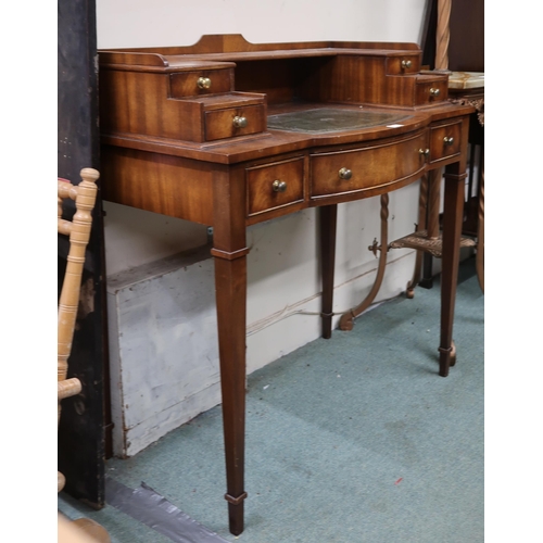 1 - A 20th century reproduction mahogany writing desk with four drawered superstructure over central dra... 