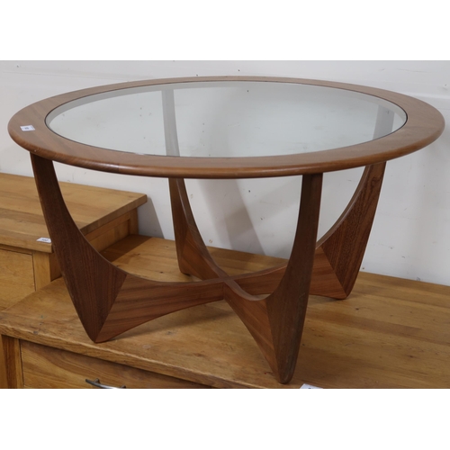 100 - A mid 20th century teak G Plan Astro circular glass inset coffee table on shaped supports, 46cm high... 