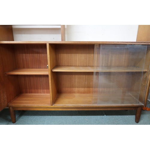 104 - A mid 20th century teak shelving unit with open shelves over cabinet door alongside glass sliding do... 