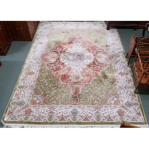 118 - A green floral patterned ground Keshan rug with cream and terracotta ground central medallion and cr... 