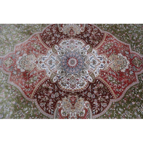 118 - A green floral patterned ground Keshan rug with cream and terracotta ground central medallion and cr... 