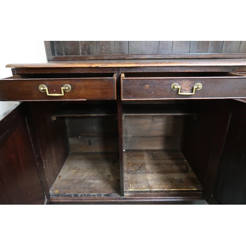 128 - A 19th stained oak kitchen dresser with open plate rack over three drawers over three cabinet doors ... 